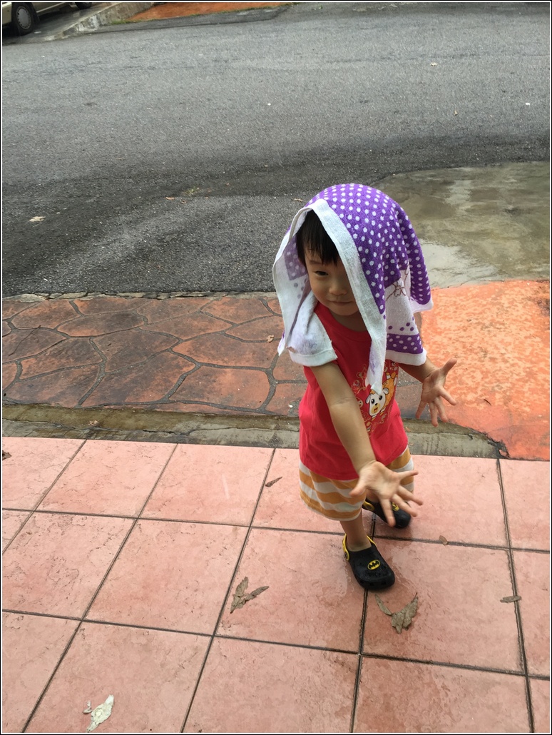Toddler playing in the rain